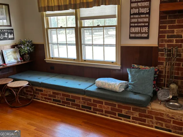 a living room with furniture rug and wooden floor
