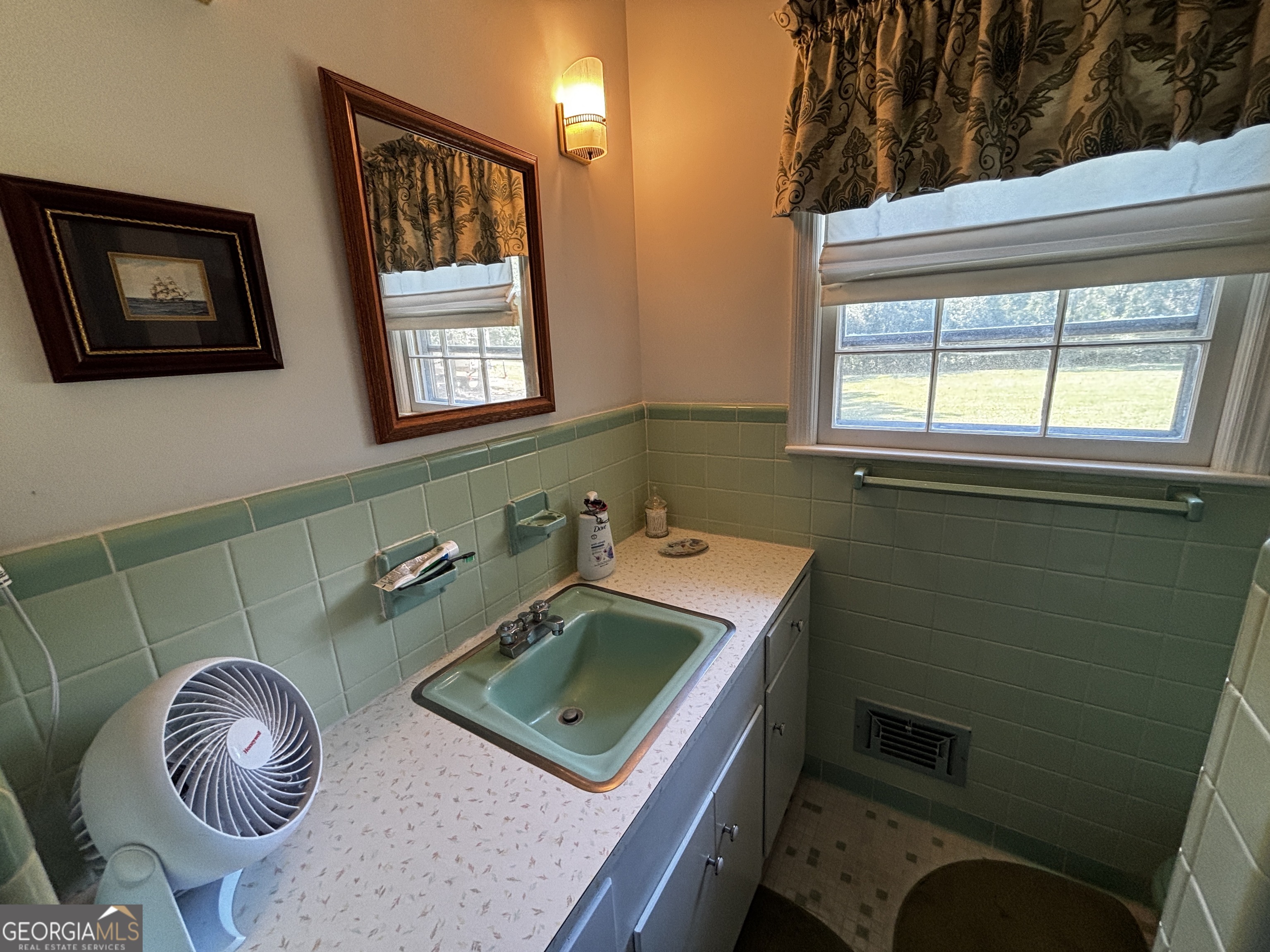 207 Old Thomson Road Wrens, GA 30833 - Photo 37 of 46 a bathroom with a sink a toilet and a mirror