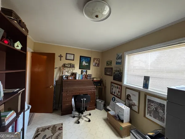 a view of a livingroom with furniture and a window