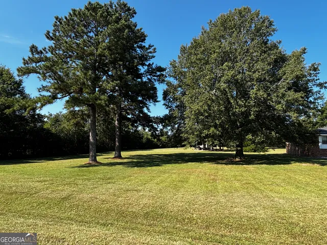 a view of outdoor space with swimming pool and green space