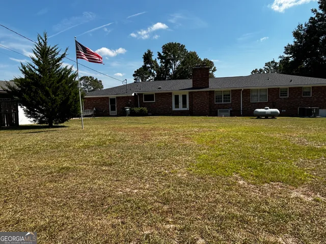 a front view of house with yard and trees