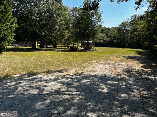 a view of yard with swimming pool and green space