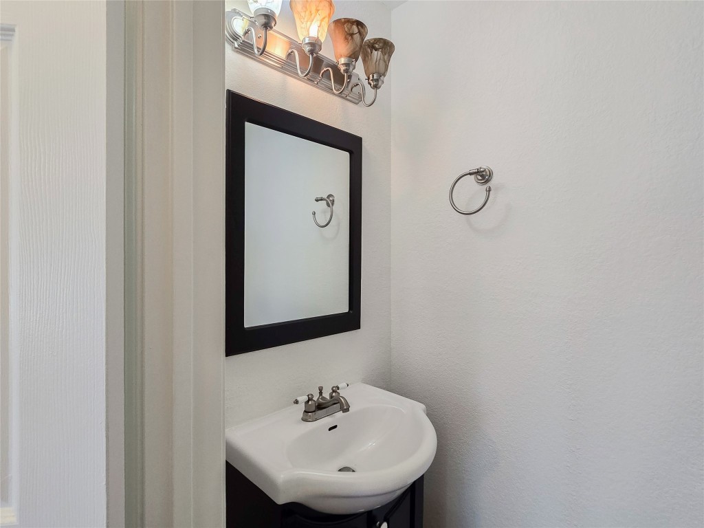 8021 Rimini Trail Austin, TX 78729 - Photo 13 of 26 a bathroom with a sink a mirror and a toilet