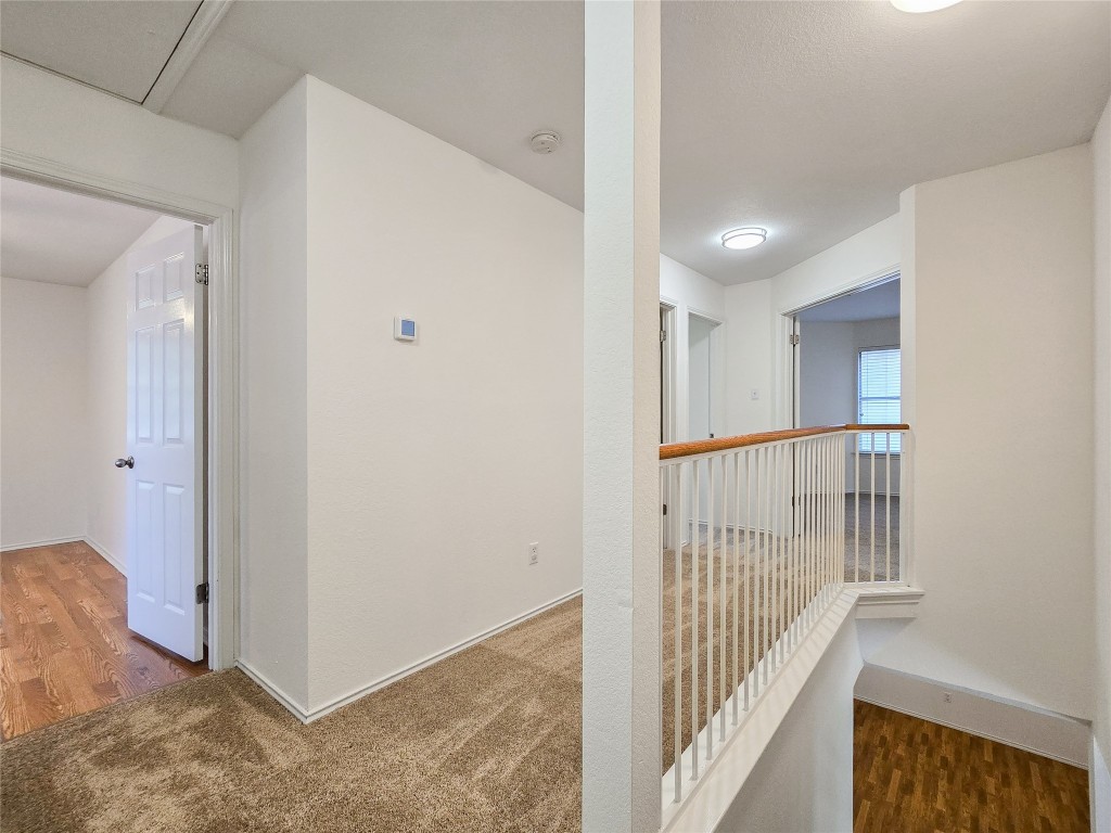 8021 Rimini Trail Austin, TX 78729 - Photo 16 of 26 a view of a hallway with wooden floor and entryway