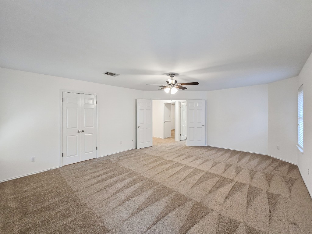 8021 Rimini Trail Austin, TX 78729 - Photo 18 of 26 a view of an empty room with a chandelier fan