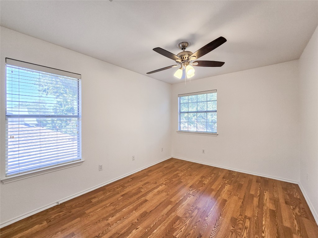 8021 Rimini Trail Austin, TX 78729 - Photo 24 of 26 wooden floor in an empty room with a window