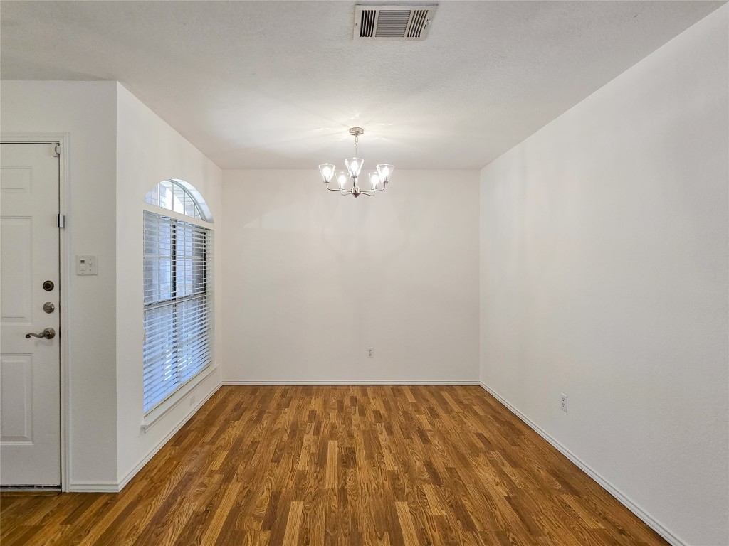8021 Rimini Trail Austin, TX 78729 - Photo 5 of 26 a view of empty room with wooden floor