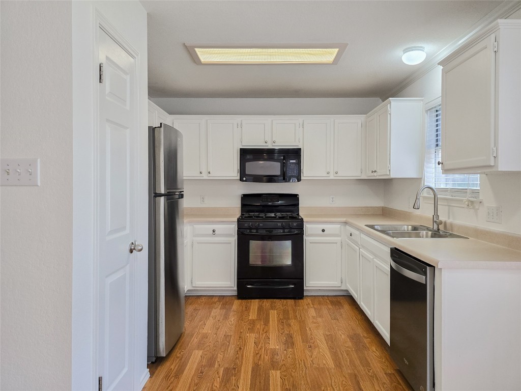 8021 Rimini Trail Austin, TX 78729 - Photo 7 of 26 a kitchen with stainless steel appliances granite countertop a stove and a refrigerator