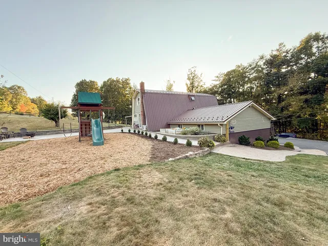 a view of a swimming pool with a playground and mountain view
