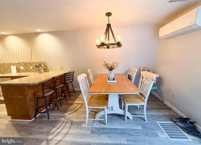 a large kitchen with a lot of counter space and wooden floor