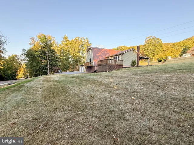 a large house with a mountain in front of it