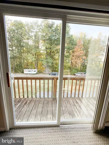 a view of a livingroom with wooden floor and a window