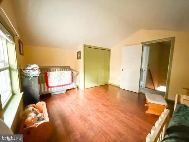 a bed sitting in a bedroom and chair