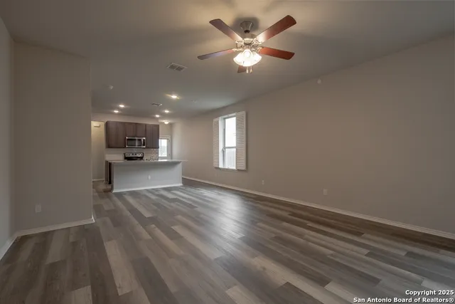 wooden floor in an empty room with a window