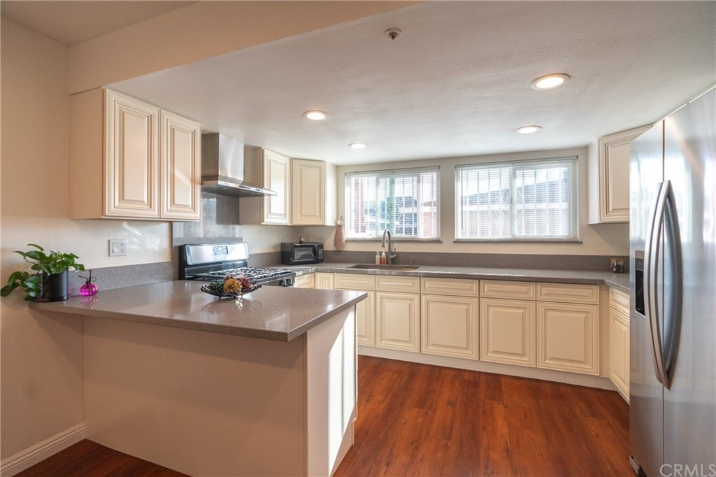 1938 Strathmore Avenue San Gabriel, CA 91776 - Photo 1 of 1 a kitchen with stainless steel appliances granite countertop a refrigerator sink and white cabinets