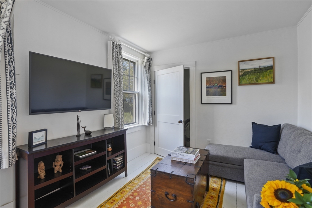 187 Lagoon Pond Road Tisbury, MA 02568 - Photo 14 of 27 a living room with furniture and a flat screen tv