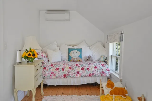 a bedroom with furniture and a window