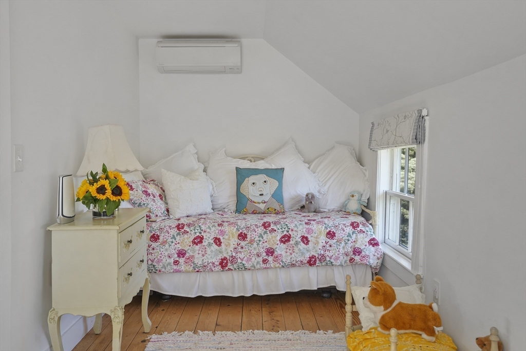 187 Lagoon Pond Road Tisbury, MA 02568 - Photo 20 of 27 a bedroom with a bed and wooden floor