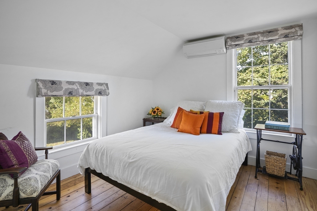 187 Lagoon Pond Road Tisbury, MA 02568 - Photo 22 of 27 a bedroom with a bed and wooden floor