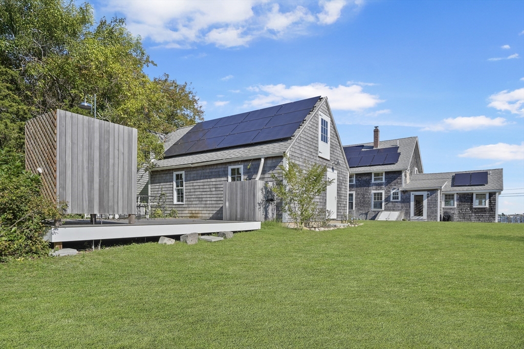 187 Lagoon Pond Road Tisbury, MA 02568 - Photo 25 of 27 a view of a house with a yard porch and sitting area