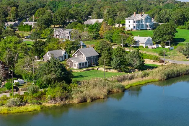 an aerial view of a house with a yard and a large pool