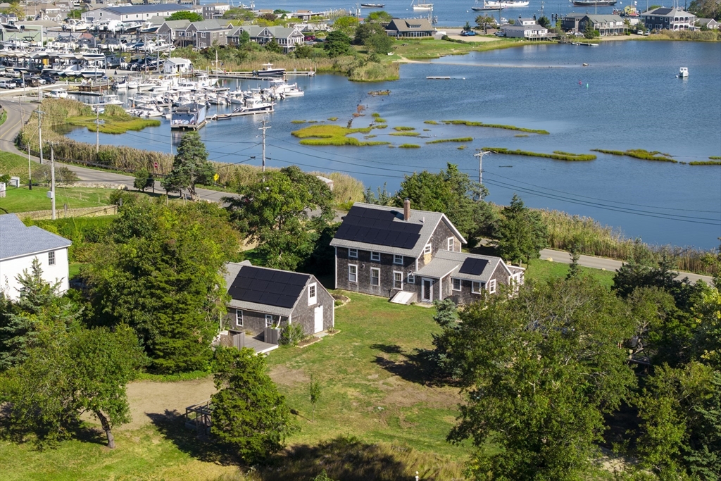 187 Lagoon Pond Road Tisbury, MA 02568 - Photo 3 of 27 an aerial view of a house with a lake view