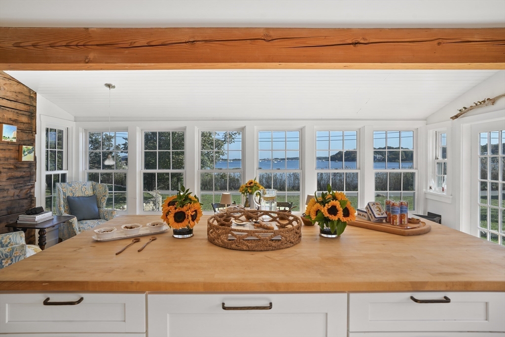 187 Lagoon Pond Road Tisbury, MA 02568 - Photo 6 of 27 a room with wooden floor and large windows