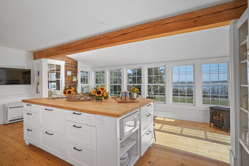 187 Lagoon Pond Road Tisbury, MA 02568 - Photo 7 of 27 a dining hall with stainless steel appliances granite countertop a sink and a large window