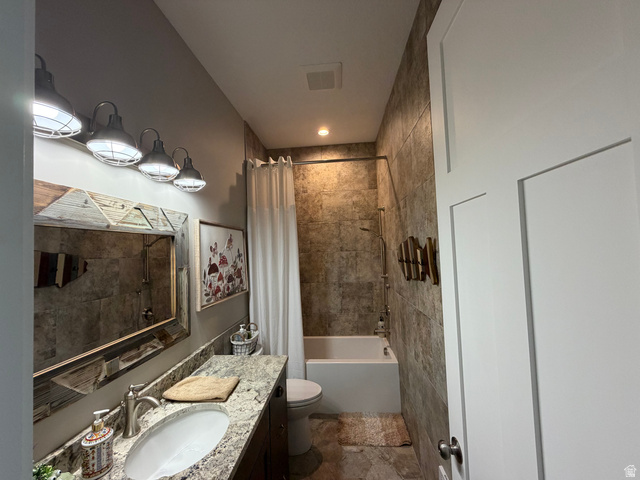 1325 South Round Road East Laketown, UT 84038 - Photo 30 of 40 Bathroom featuring a full-sized bathtub with shower, tiled walls, and a single vanity with stone countertop
