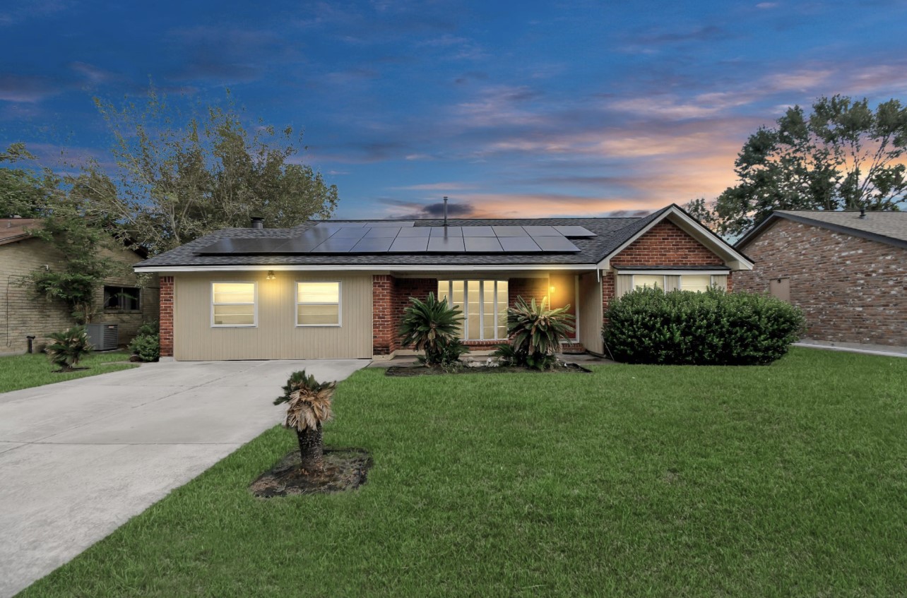 a front view of a house with a garden