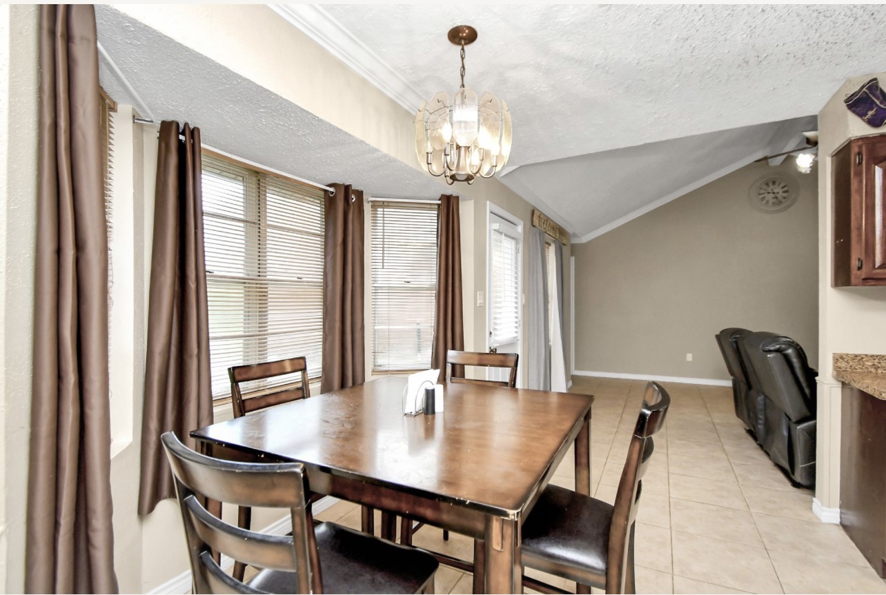 712 Meadowick Drive Baytown, TX 77521 - Photo 19 of 21 a view of a dining room with furniture and window