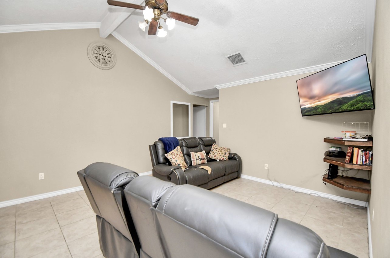 712 Meadowick Drive Baytown, TX 77521 - Photo 20 of 21 a living room with furniture and a flat screen tv