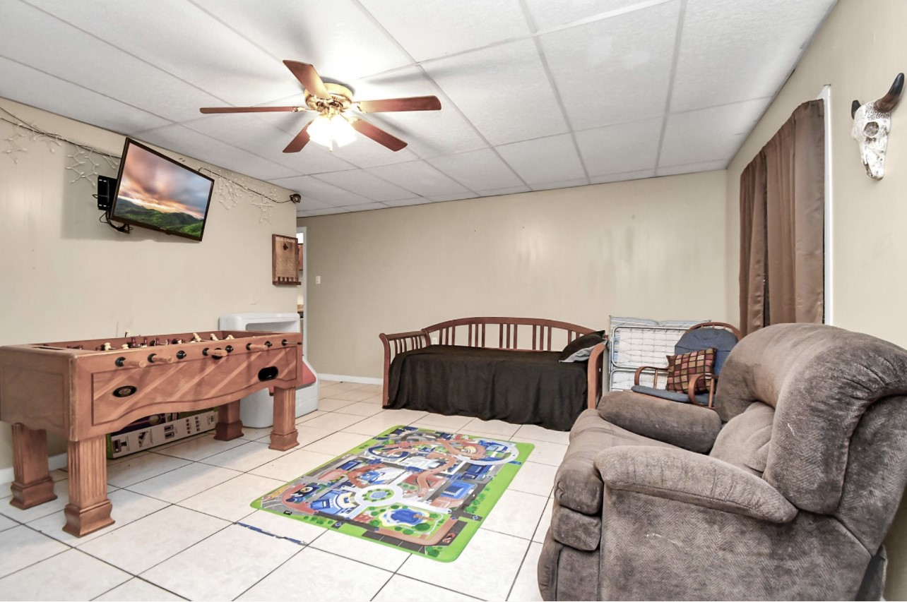 712 Meadowick Drive Baytown, TX 77521 - Photo 7 of 21 a living room with furniture and a flat screen tv