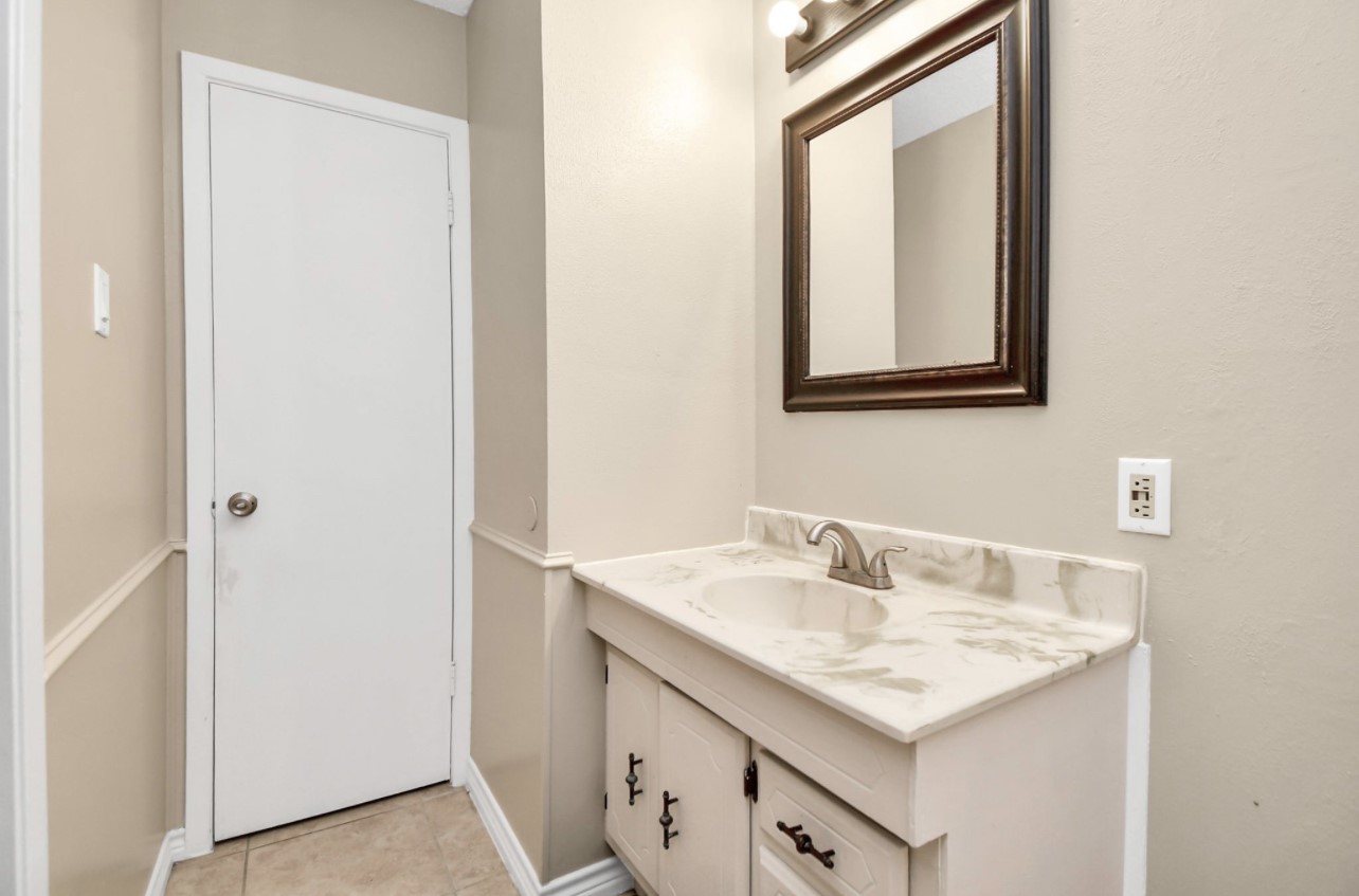 712 Meadowick Drive Baytown, TX 77521 - Photo 9 of 21 a bathroom with a sink and a mirror