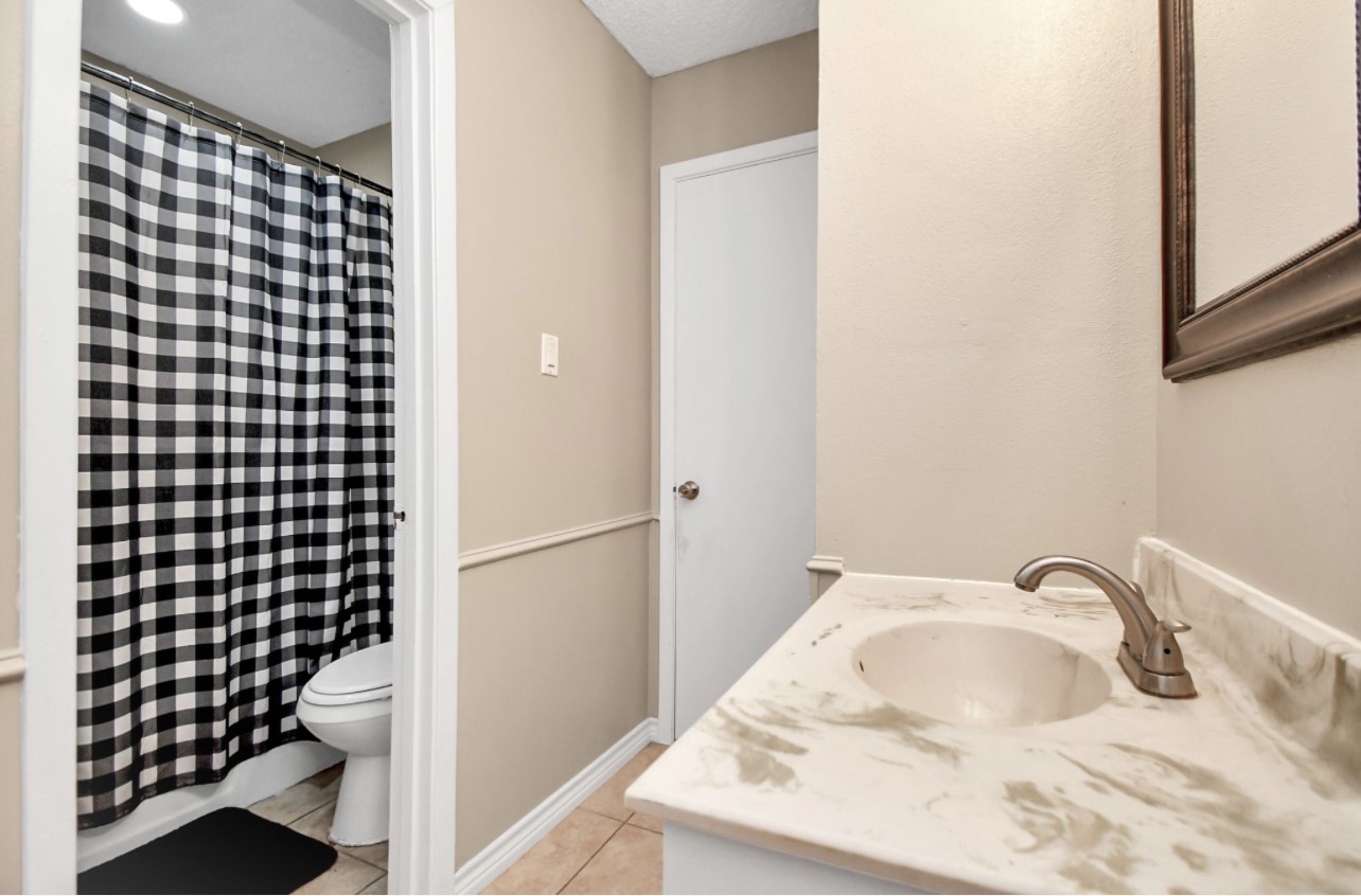 712 Meadowick Drive Baytown, TX 77521 - Photo 10 of 21 a bathroom with a sink and mirror