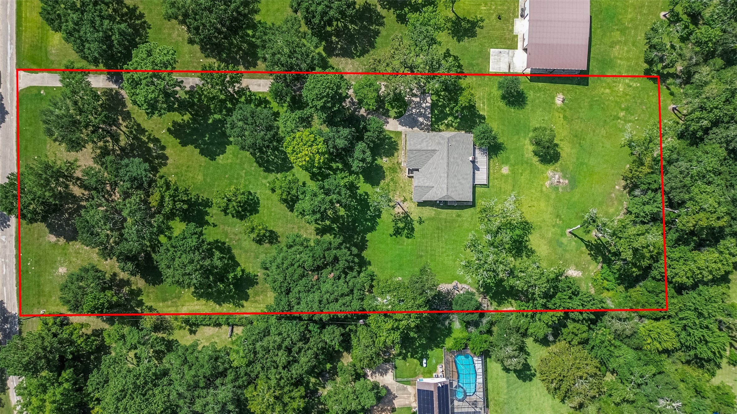 an aerial view of a house with a yard and lake view