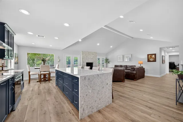 a large kitchen with stainless steel appliances lots of counter space and furniture