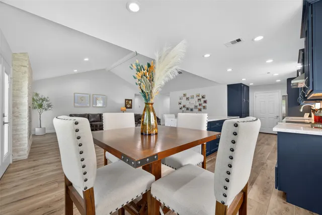 a dining room with furniture and wooden floor