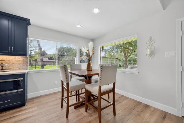 a dining room with furniture and window