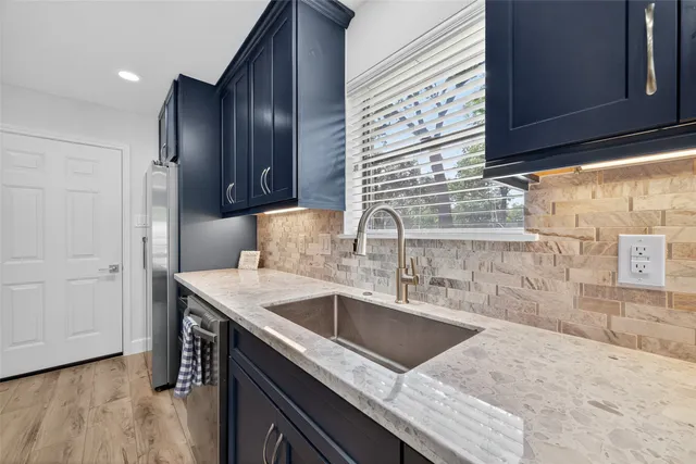 a kitchen with a sink stove and cabinets