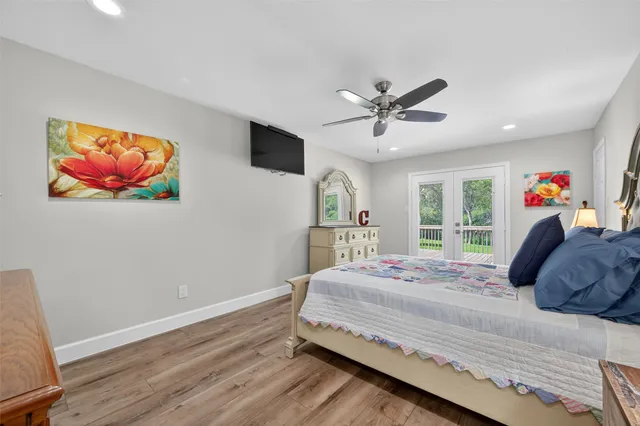 a bedroom with a bed and a painting on the wall
