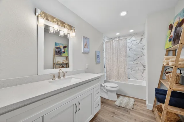 a bathroom with a double vanity sink toilet and shower