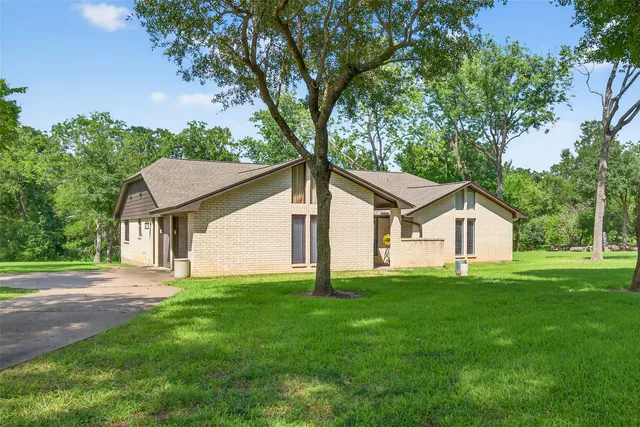 a front view of house with yard and green space