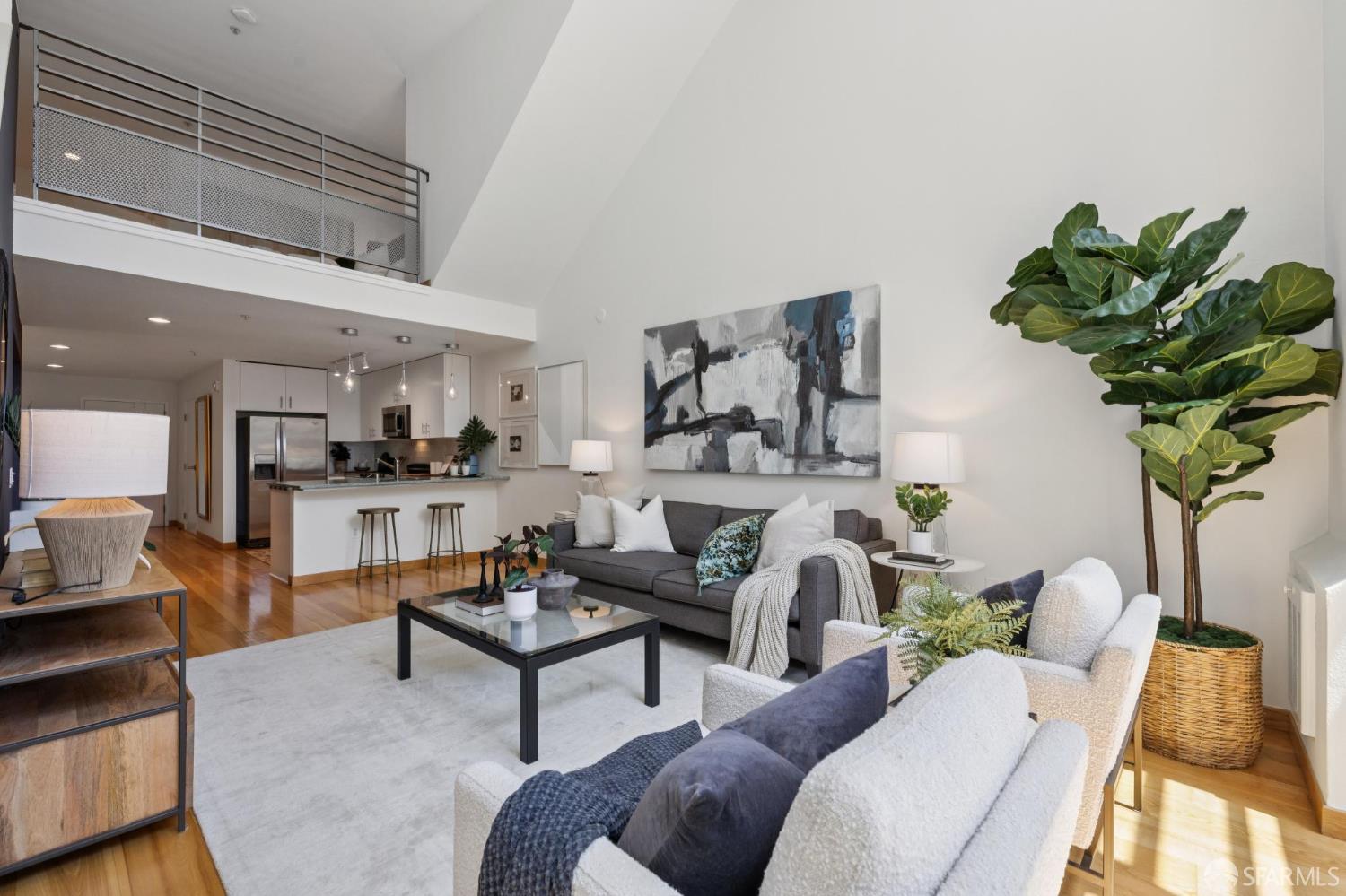 a living room with furniture a chandelier and a potted plant
