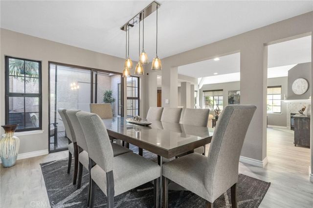 a view of a dining room with furniture and chandelier