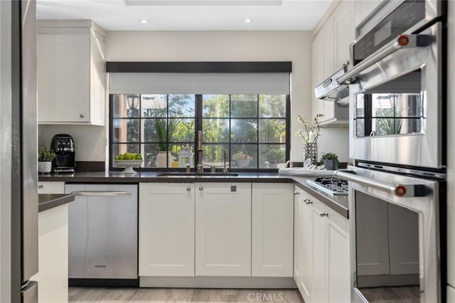 a kitchen with counter top space and stainless steel appliances
