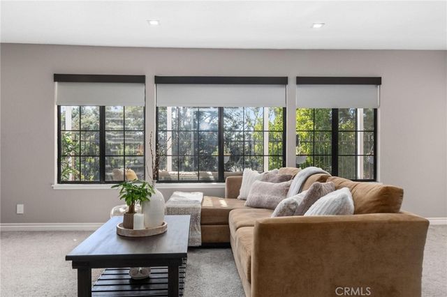 a view of a kitchen area with furniture and wooden floor