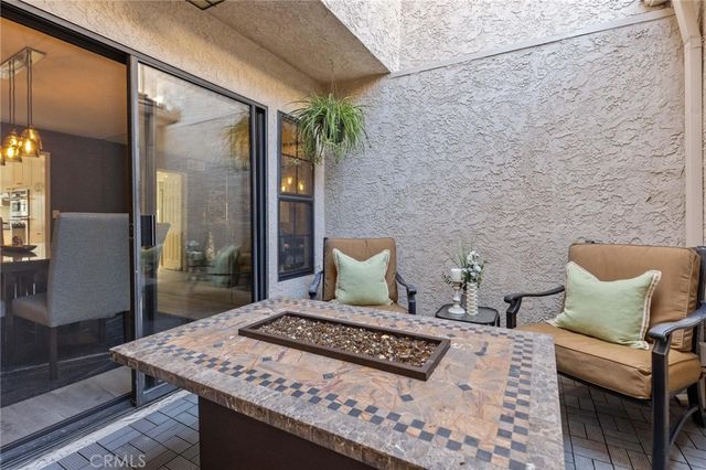 a dining room with furniture a chandelier and wooden floor