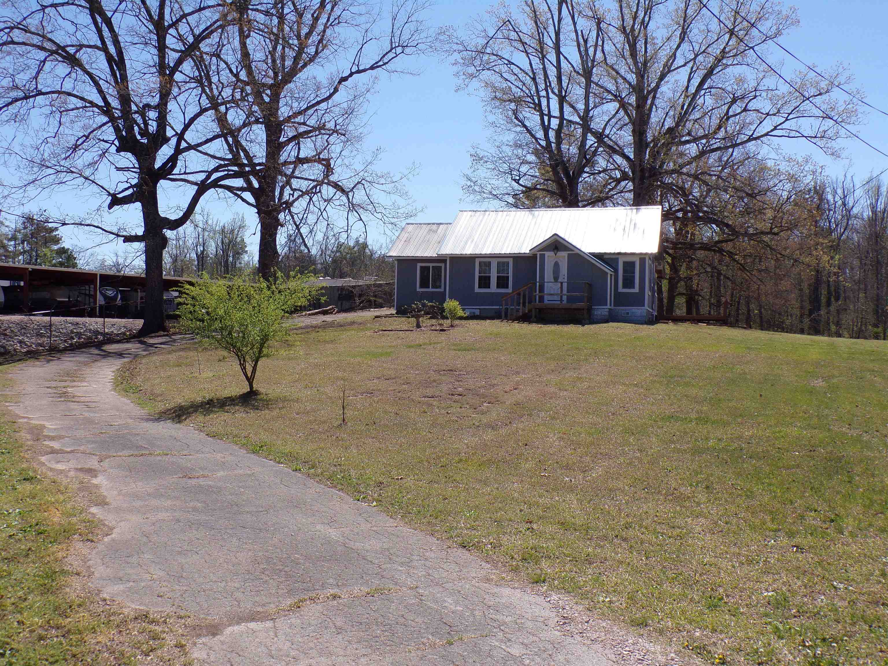 5950 Highway 57 Counce, TN 38326 - Photo 1 of 23 View of front facade featuring a metal roof and a front yard