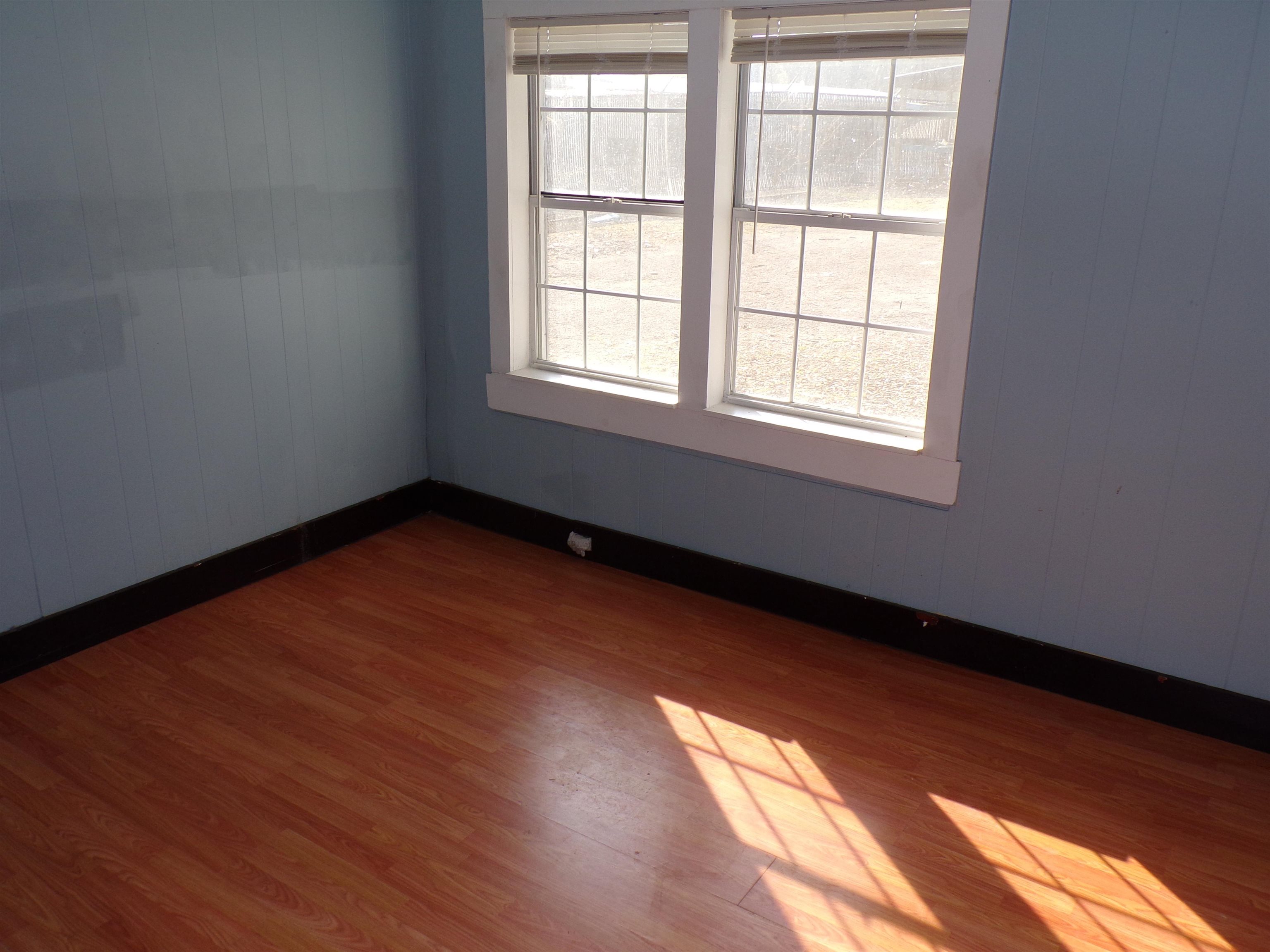 5950 Highway 57 Counce, TN 38326 - Photo 12 of 23 Spare room with dark wood-style flooring and wooden walls
